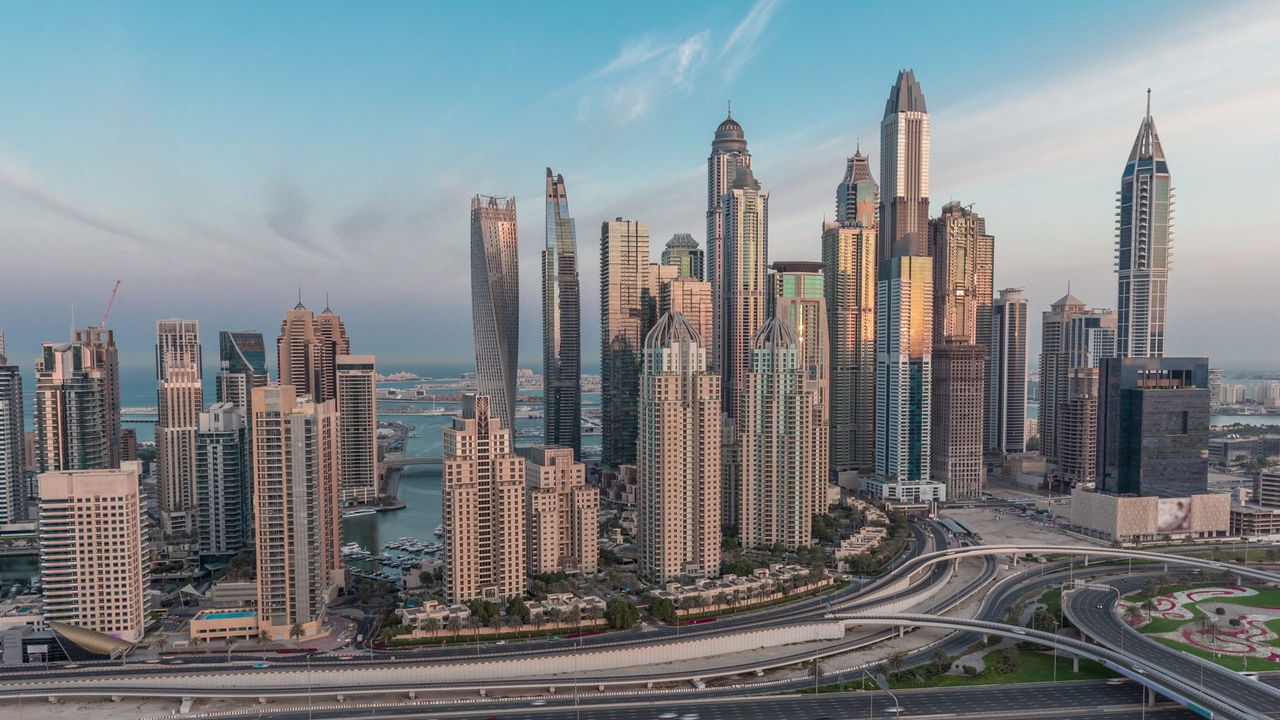Aerial view of Dubai Marina high-rise towers and highway interchange