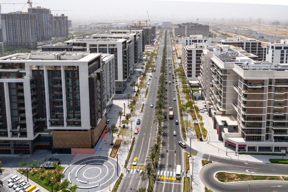 Aerial view of a Dubai street lined with residential buildings served by district cooling.